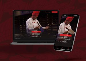 Laptop and smartphone display a chef in a red hat and coat, performing a culinary action. 